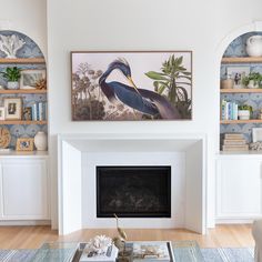 a living room filled with furniture and a fire place under a painting on the wall