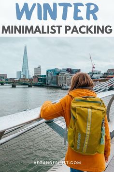 a woman with a backpack looking out over the water and text that reads winter minimalist packing