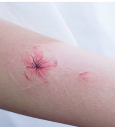 a woman's arm with pink flowers on it