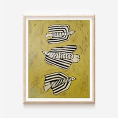 three black and white striped fish on yellow background framed in wooden frame with wood trim