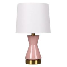 a pink and gold lamp with a white shade on the top, sitting against a white background