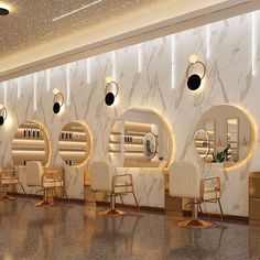 the interior of a hair salon with chairs and mirrors on the wall, lights hanging from the ceiling