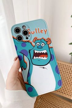 a person holding up a phone case with an image of a cartoon character on it