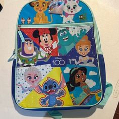 Send The Kids Back To School Or The Disney With Disney 100th Anniversary Backpack. A Keepsake For Sure! Disney Blue Bags For End Of School Year, Cute Multicolor Backpack For Disney Trips, Playful Backpack For Disney Trips, Blue Character Backpack For Disney Trips, Disney Blue Standard Backpack, Themed Blue Backpack For End Of School Year, Disney Backpack For End Of School Year, Fun Multicolor Backpack For Disney Trips, Disney Style Blue School Backpack