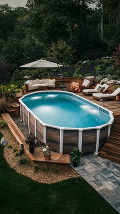 an above ground pool surrounded by decking and lounge chairs