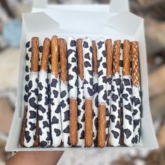 a box filled with pretzels covered in white and black animal print wrappers