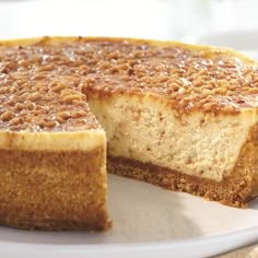 a cheesecake on a plate with one slice cut out