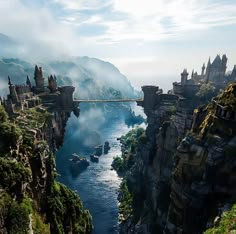 an aerial view of a castle on the edge of a cliff with a river running through it