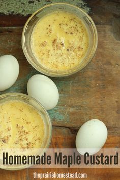 homemade maple custard in two glass bowls with an egg next to it on a wooden table