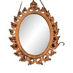 an ornate gold mirror hanging on a wall