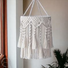 Macrame Lamp Shape, Macrame Decor, Light Lamp, Ceiling Hanging Decor, Boho Chandelier, Handmade Home Decor, Pendant Lamp Shade, Home Gift Elevate your space with our exquisite Macrame Lamp Shape in white. This stunning macrame decor piece doubles as a captivating pendant lamp shade, creating a boho chandelier effect that infuses natural charm and warmth into any room. Handcrafted with precision, this tassel lamp shade is a unique blend of artistry and functionality. Welcome the soothing, ambient Unique Lamp Shades Macrame, Macramé Lamp Shade, Macrame Desk Lamp Shade, Shabby Chic Lamp Shades Macrame, Plug In Chandelier Macrame, Macrame Lamp Tutorial, Macrame Chandelier Tutorial, Boho Light Fixture, Macrame Light