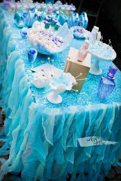 a table topped with blue and white desserts