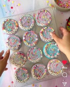 someone is decorating decorated cookies with sprinkles