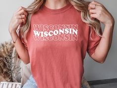 DESCRIPTION The Wisconsin Shirt is printed on a Comfort Colors® 1717 brand. tshirt with a high quality permanent vinyl.  We offer various colors when ordering. Please note that colors may appear slightly different on monitors or with different lighting. Please reference the color chart in the listing. SIZING Shirts are unisex sizing. Please see item photos for a sizing chart. For women, please order your normal numerical size if you are looking for a more regular fit. Note that these already do Fan Merchandise Short Sleeve T-shirt With Heat Transfer Vinyl, Crew Neck T-shirt With Heat Transfer Vinyl For Fans, Graphic Tee T-shirt With Heat Transfer Vinyl, Relaxed Fit Crew Neck Tops With Heat Transfer Vinyl, Graphic Tee Shirt With Heat Transfer Vinyl For Fans, Casual T-shirt With Heat Transfer Vinyl And Crew Neck, Wisconsin Flag, Brand Tshirt, Comfort Colors Shirt