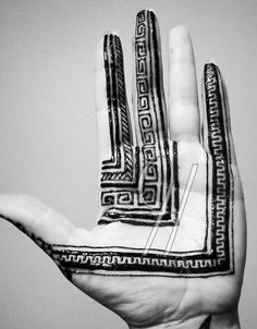 a person's hand with an intricate design on the inside of it, in black and white