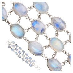 Twenty large 10 x 14 mm oval cabochons of blue sheen rainbow moonstones are arranged in 3 offset linkages in simple handmade bezels in this one of a kind bracelet. Each stone is attached to the others nearby via multiple jump rings to fit comfortably over the wrist and move gently with each movement. The two large toggle rings allow for the possibility to fit either a larger (7 inch) or smaller (6 1/2 inch) wrist size. Nice! Modern Bracelets, Rainbow Bracelet, Oval Cabochon, Moon Stone, Jump Rings, Rainbow Moonstone, Sterling Silver Bracelets, Moonstone, Silver Bracelet