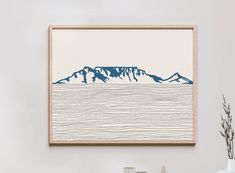 an art print with mountains in the background