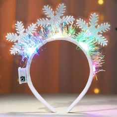 PRICES MAY VARY. Light up Snowflakes hair band is made of shiny 3 snowflake patterns and colorful ribbon decoration, Christmas headband combined with 3 speed adjustable LED lights, making you sparkle and charm at parties. Snowflake headband is approx 7.7*7.3 inches/19.5*18.5 cm, and the high elasticity headband makes snowflake costume women suitable for most adults and kids. Snowflakes hair accessories are lightweight and easy to carry,snowflake costumes are comfortable to put on and off. Walk or dance without worrying about slipping off,wearing snowflake lights hair decorations when going out can add to your outfit. Xmas LED hairband suitable for Christmas,Halloween,Cosplay,Party,Festival,Xmas,Holiday,Birthday,New Year,Carnival,Costume Parties,Daily,Christmas LED headband also a wonderful Xmas Hair Accessories, Snowflake Lights, Snowflake Patterns, Ribbon Decoration, Christmas Hair Accessories, Colorful Ribbon