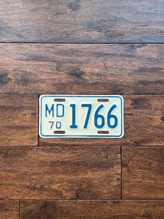 an old license plate on a wooden floor