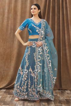 Teal blue lehenga with floral embroidered motifs. Comes with blouse and dupatta.
Components:3
Pattern:Embroidery
Type of Work:Sequin, Beads, Thread and Cutdana
Neckline:V neck
Sleeve Length:Half
Fabric:Moda Silk and Organza
Color:Blue
Other Details:
Blouse with cutwork detail
Sheer dupatta with embroidered motifs and cutwork border
Low back with tie up and tassels
Occasion:Wedding - Aza Fashions Teal Blue Lehenga, V Neck Lehenga, Sheer Dupatta, Organza Embroidery, Embroidered Motifs, Blue Lehenga, Embroidered Lehenga, Pattern Embroidery, Fashion App