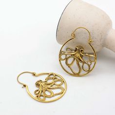 Dive into a world of oceanic charm with our brass octopus earring, featuring a stunning gold Kraken detail that brings a playful yet elegant touch to any outfit. 🎉 Hurry! Purchase within the next 24 hours to get your exclusive offer! Apply this promo code[TRIS1234] and get 38% off. IMPORTANT NOTE....👇 you will also get a surprise gift🎁on every purchase. 💥Explore more unique designs in my shop here:  https://www.etsy.com/shop/bohojwellerybazar Handmade Ocean-inspired Gold Earrings, Gold Ocean-inspired Earrings, Ocean-inspired Gold Jewelry With Ear Wire, Nickel Free Gold Ocean-inspired Earrings, Nickel Free Ocean-inspired Gold Earrings, Octopus Earrings, Brass Hoop Earrings, Brass Hoops, Animal Earrings