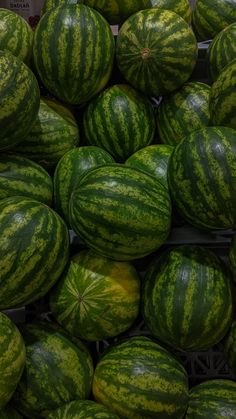 a pile of watermelons sitting next to each other