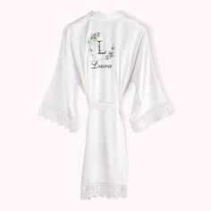 a white robe with lace trims and the word i love geneva written on it