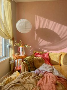 a living room filled with furniture and a large window next to a wall covered in curtains