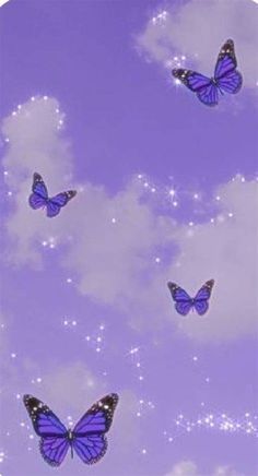 there are many blue butterflies flying in the sky with stars and clouds behind them on a purple background