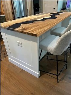 a kitchen island made out of wood and white cabinets