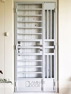 a white cabinet with glass doors and shelves