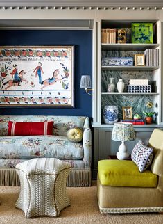 a living room filled with furniture and lots of bookshelves on top of it