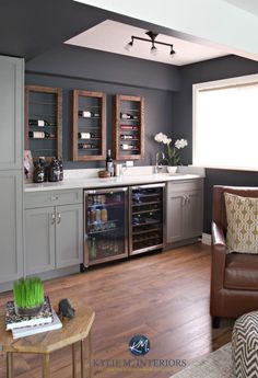 a living room filled with furniture next to a kitchen