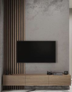 a flat screen tv sitting on top of a wooden entertainment center in a living room