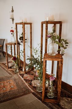 several vases filled with flowers on top of a rug