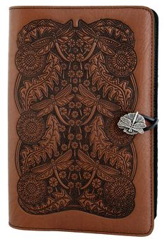 a brown leather journal with an intricate design