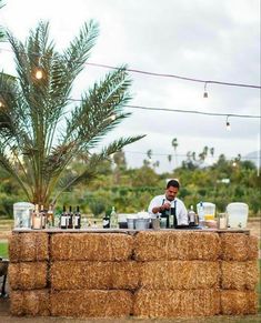 a man sitting at a bar made out of hay