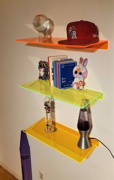 three shelves with hats, books and other items on them