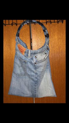 a pair of jeans hanging on a clothes rack