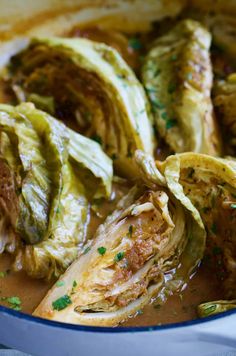 cabbage and meat in a pot with some garnish