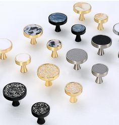 an assortment of knobs and covers on a white surface, including one with black dots