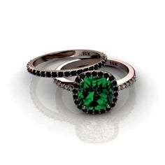 two green rings with black diamonds on each one and the other side, set in 18k white gold