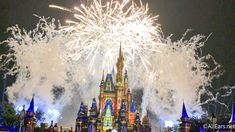 fireworks light up the night sky over a castle at disney's magic kingdom park