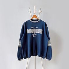 90s Dallas Cowboys NFL sweatshirt/ L * PLEASE READ BEFORE PURCHASE * PLEASE consider the PHOTOS before making the decision * The images may DIFFER in appearance from the actual product because we took pictures under daylight.  * PLEASE send your PHONE NUMBER after your purchase for the shipping company to contact you X No returns X No refund Condition : 8/10 More details : mottleds (front)/ look at the pictures  Brand : Lee Size : L Pit to pit/ Chests : 26/52 inches  Length : 28 inches  Material : cotton polyester  Color : blue  * ALL ITEMS are VINTAGE which may show some signs of wear and tear * Due to the different display and different light, the picture may not reflect the actual color of the item * Please, remember that our items are vintage so they may show some signs of wear, tear a Dallas Cowboys Cute Shirts, Cowboys Sweatshirt, Dallas Cowboys Apparel, Dallas Cowboys Sweatshirt, Dallas Cowboys Vintage Crewneck, Cowboys Hoodie, Vintage Sweaters, Dallas Cowboys, Comfy Outfits