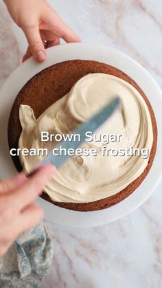 a person spreading cream on top of a cake in a white bowl with the words brown sugar cream cheese frosting