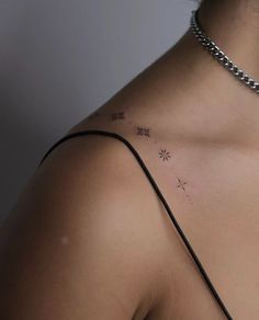 the back of a woman's shoulder with small stars on it