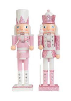 two pink and white nutcrackers are standing next to each other