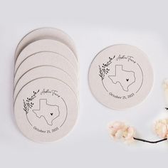 six round coasters with the names and date printed on them next to some flowers