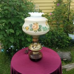 a lamp sitting on top of a purple table cloth