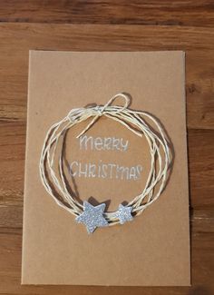 a card with two silver stars on it and the words merry christmas written in white